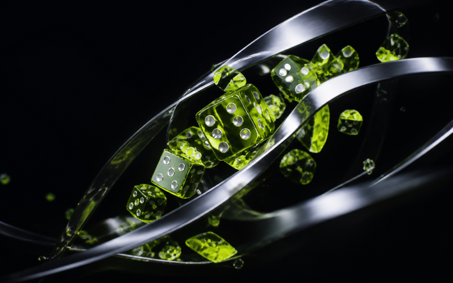 Translucent lime dice moving through silver ribbons